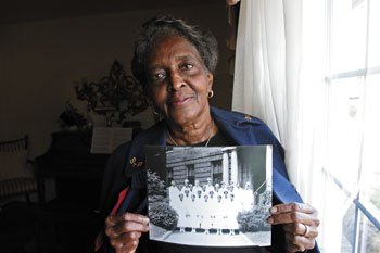 Arlethia Rogers, president of the Richmond chapter of the St. Philip Alumni Association, holds a picture of the St. Philip class of 1933.