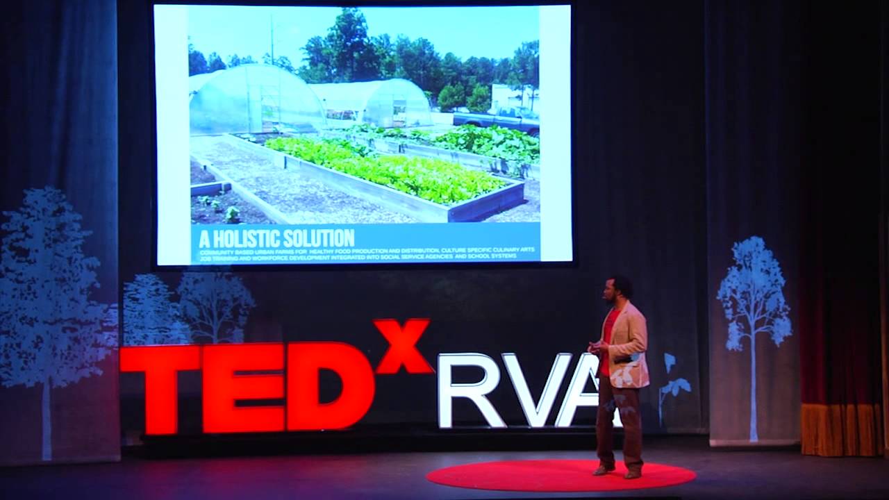 Thumbnail of Duron Chavis' talk. Chavis is standing on a red dot with a screen above him showing 